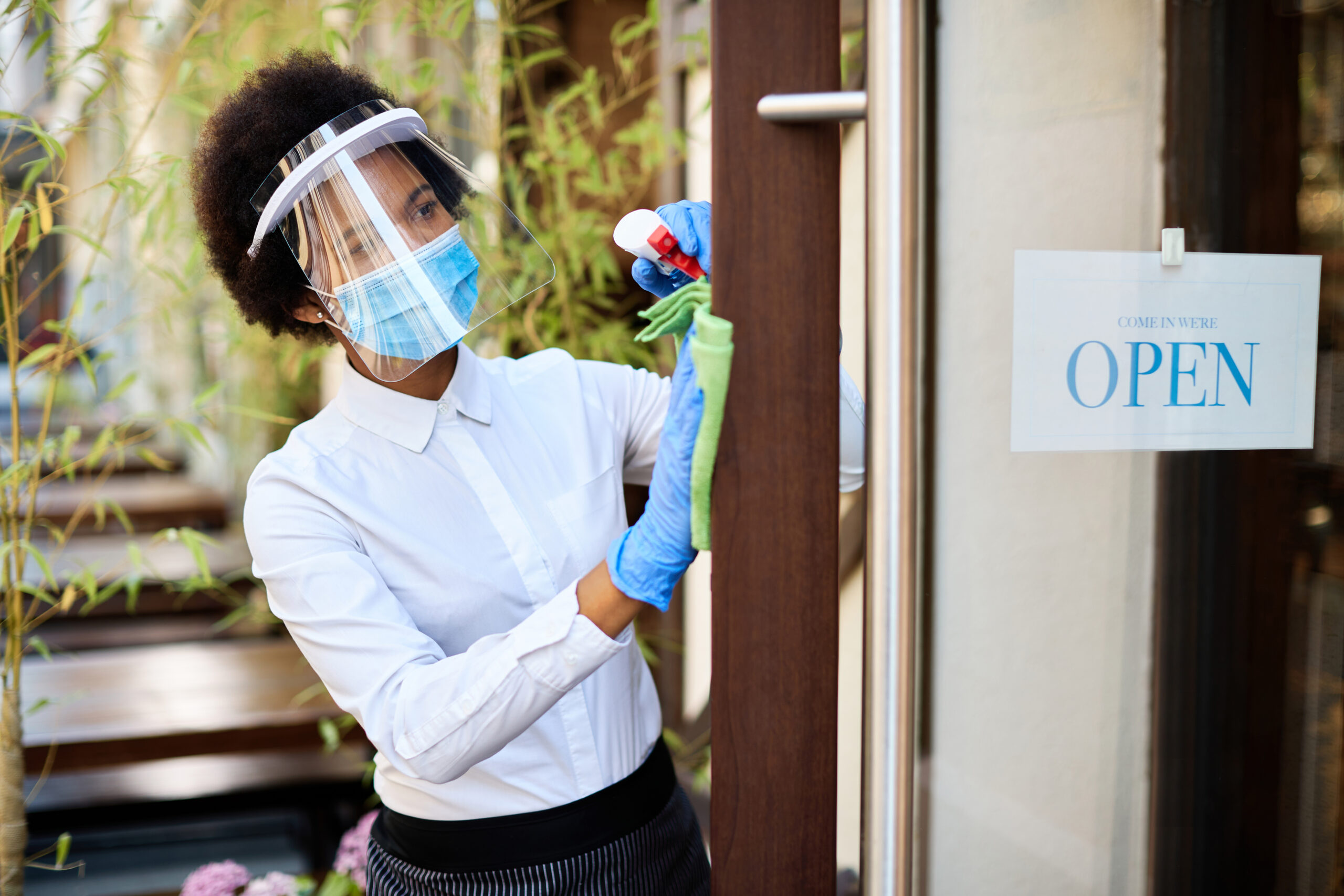 African,American,Waitress,With,Face,Mask,And,Visor,Disinfecting,Front